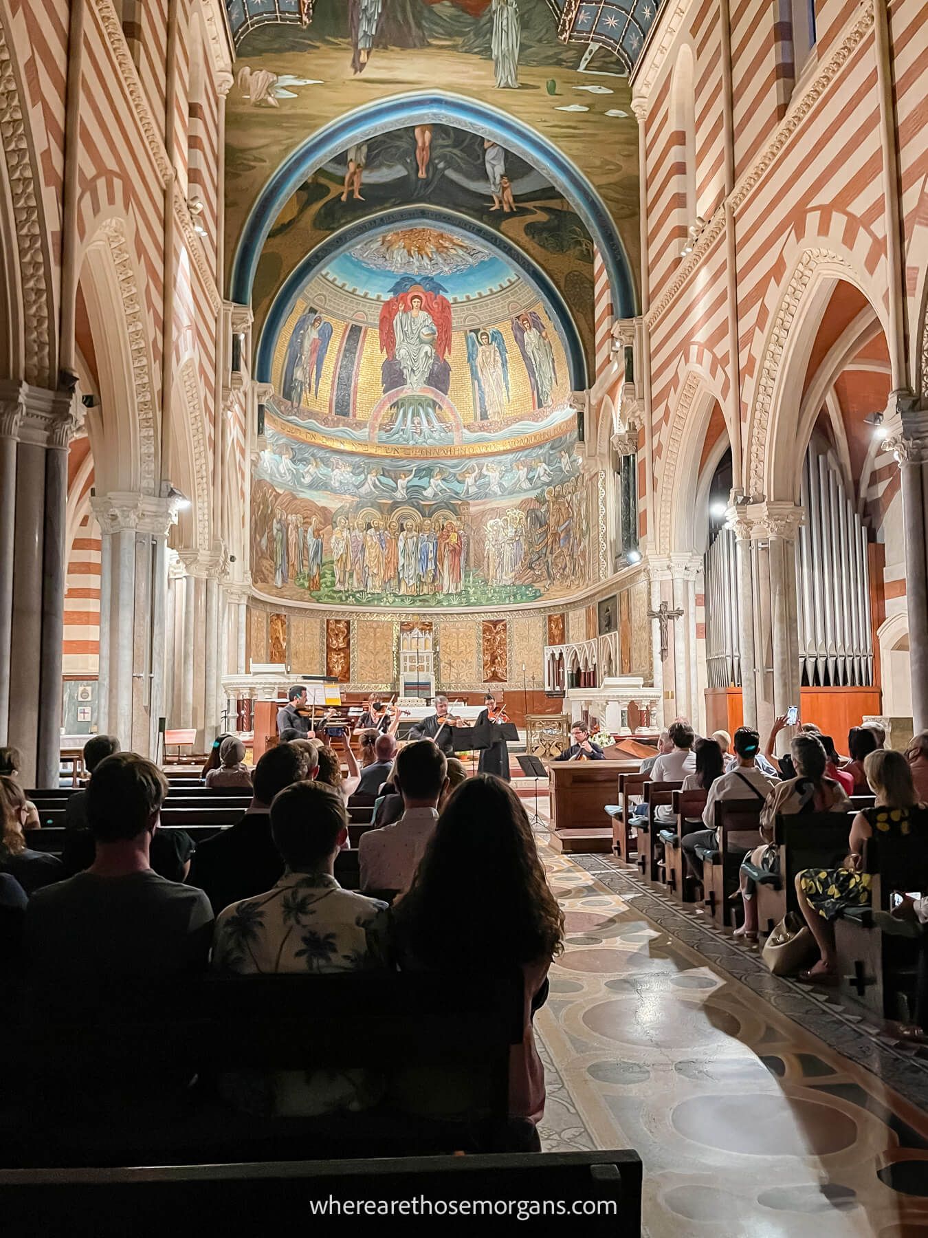 Photo of an audience watching a classical music performance inside a church