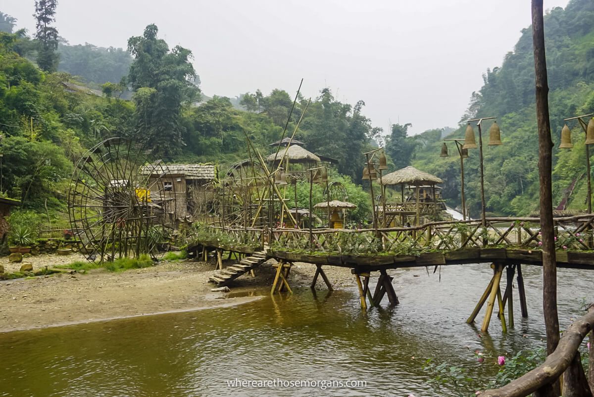 A long bamboo bridge and large water wheel in Cat Cat Village