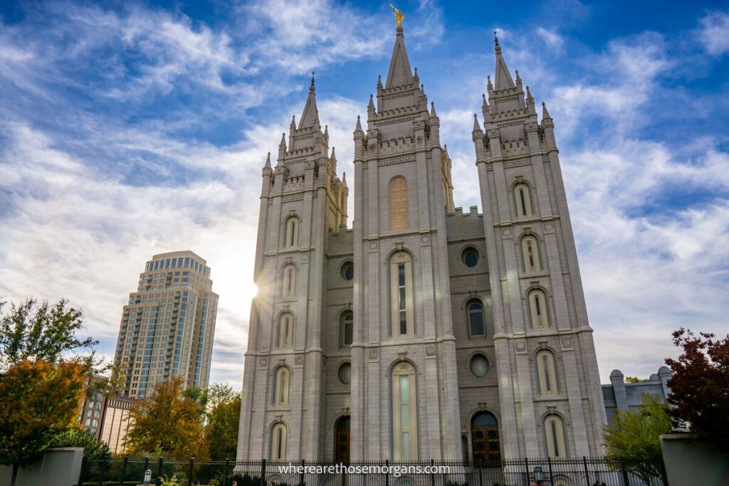 Church in Salt Lake City with starburst of the sun and wispy clouds in the sky