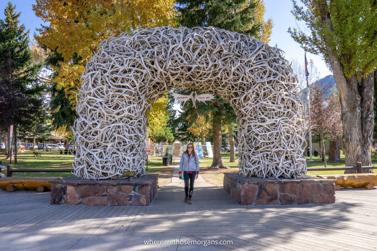 Tourist standing underneath the famous Antler Arch in Jackson Wyoming