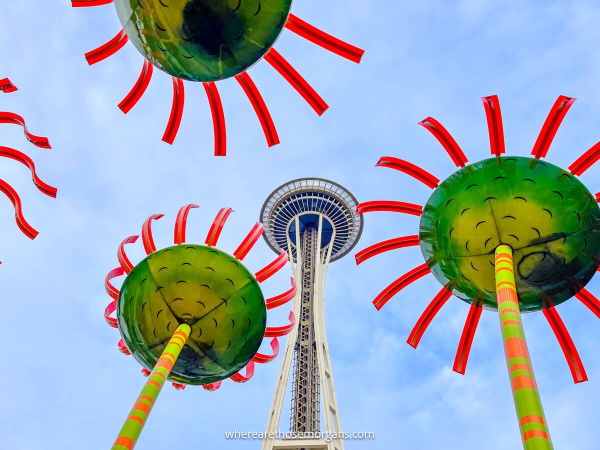 Large glass flowers outside the Pacific Science Center with the Space Needle in the background