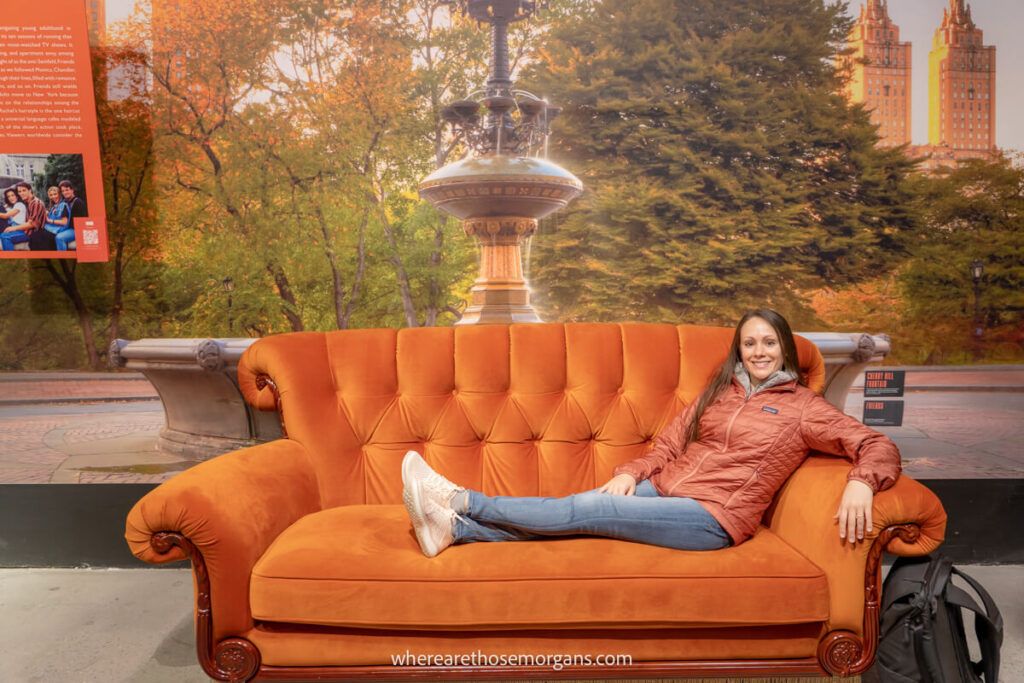 Woman sitting on a couch in nyc to compare ny passes