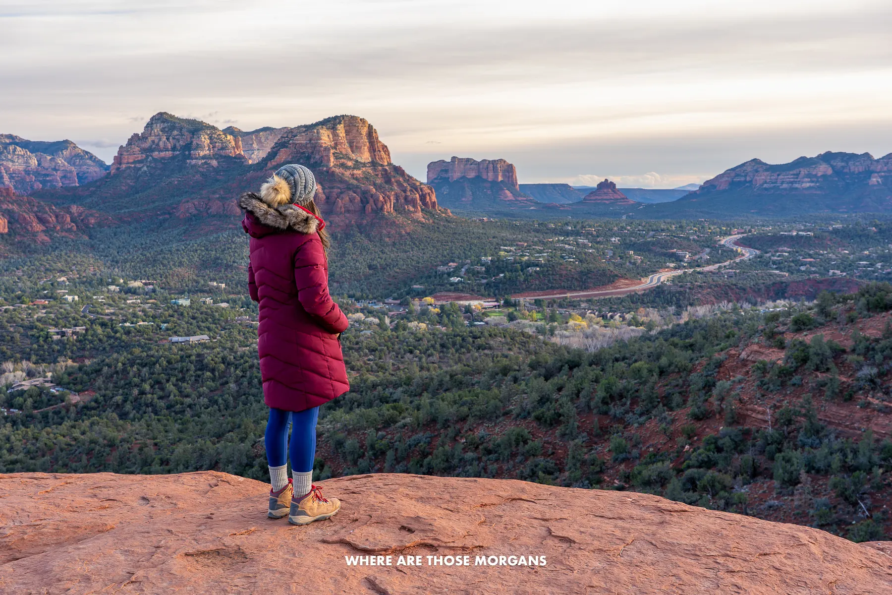 Kristen from Where Are Those Morgans looking at views of Bell Rock and south Sedona from Airport Mesa near sunset