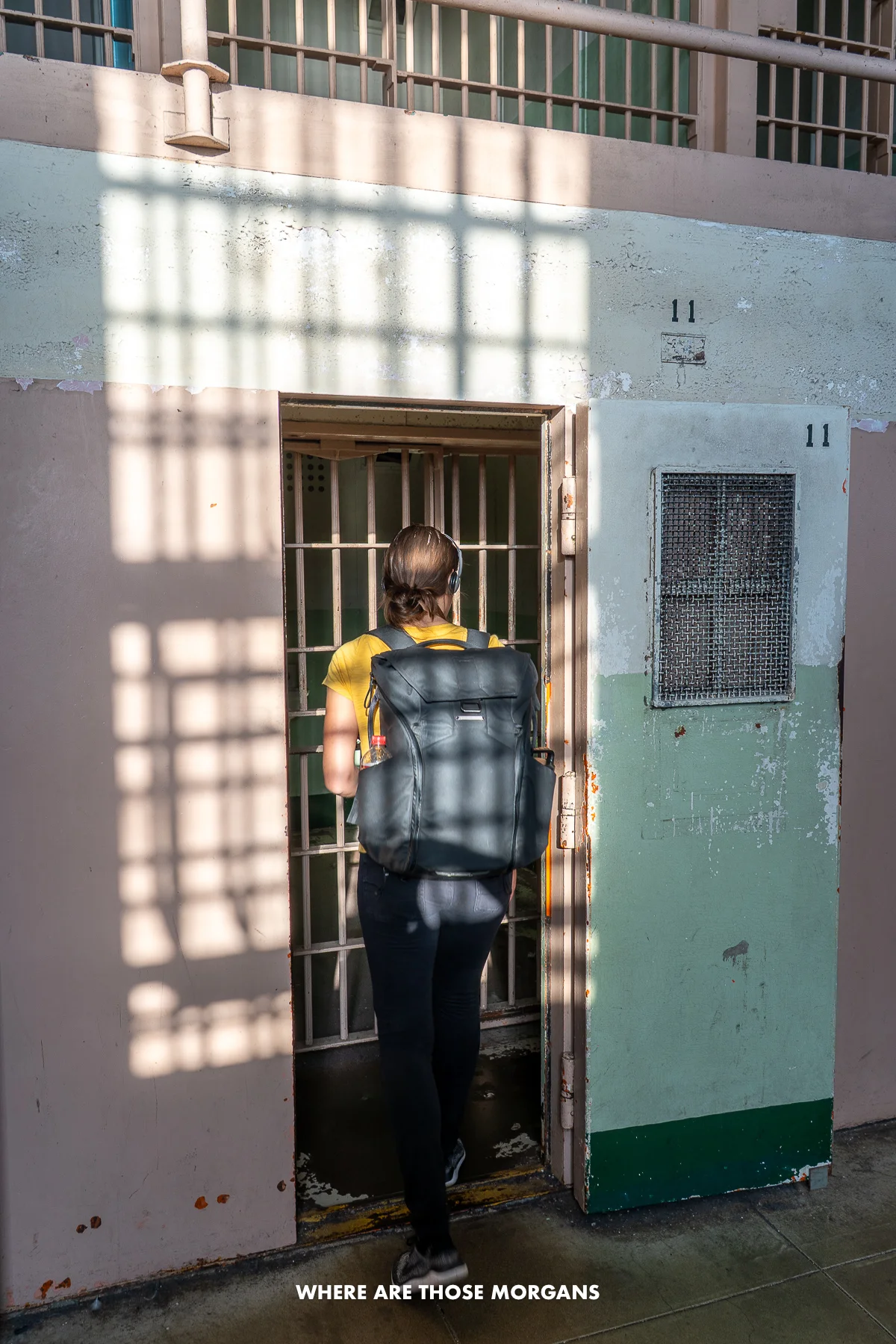Kristen from Where Are Those Morgans looking inside a jail cell inside Alcatraz