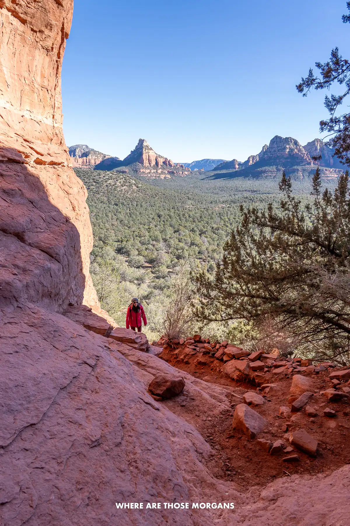Kristen from Where Are Those Morgans entering the Birthing Cave in Sedona with wide open views behind