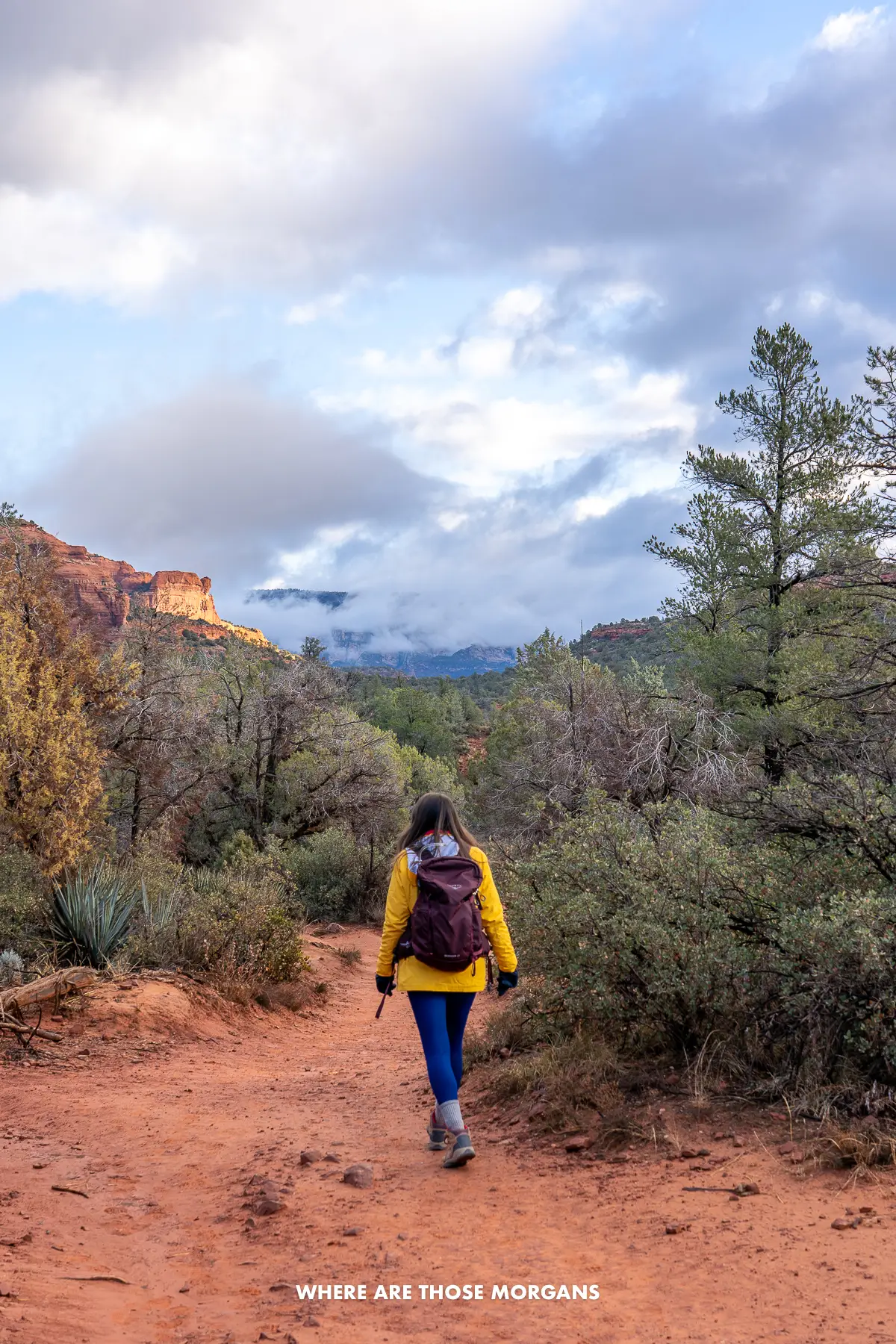 Kristen from Where Are Those Morgans hiking a dirt rock trail through vegetation in Arizona