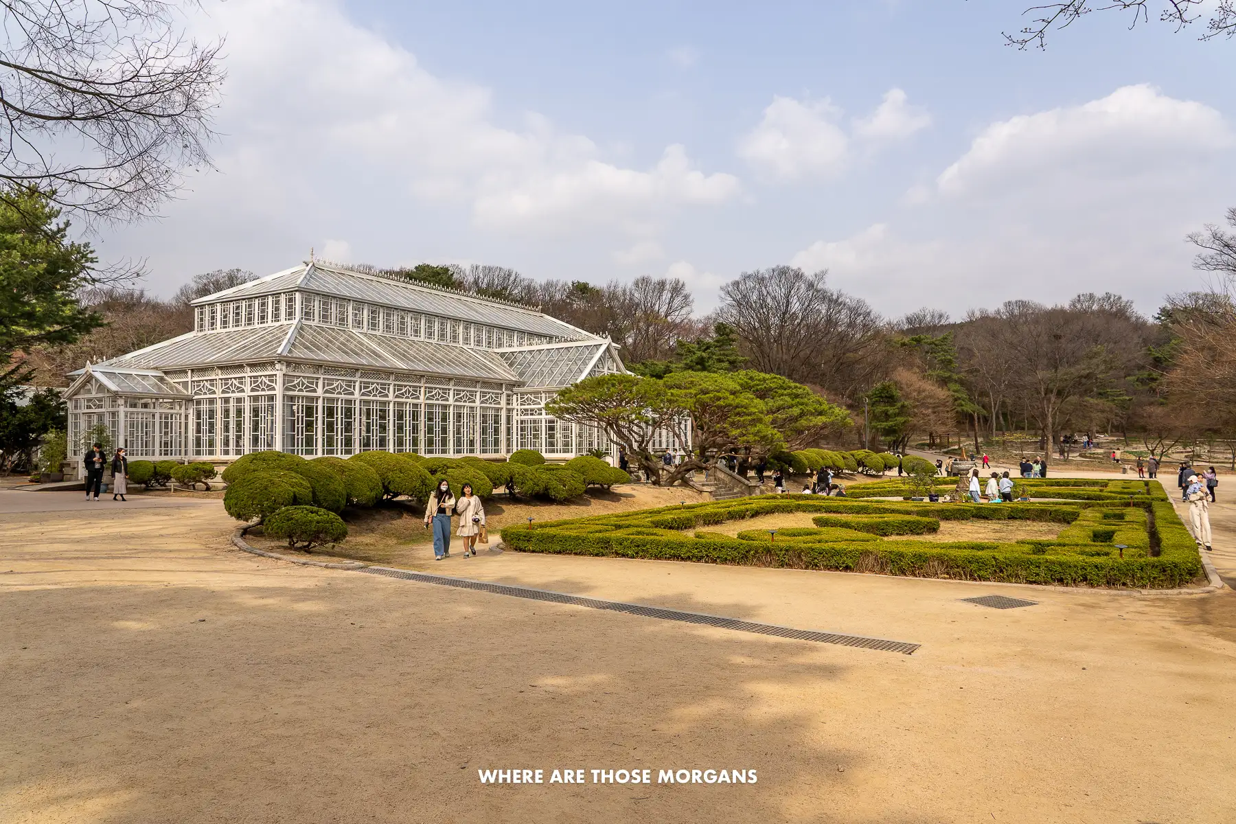 White greenhouse and small maze-like garden in a park