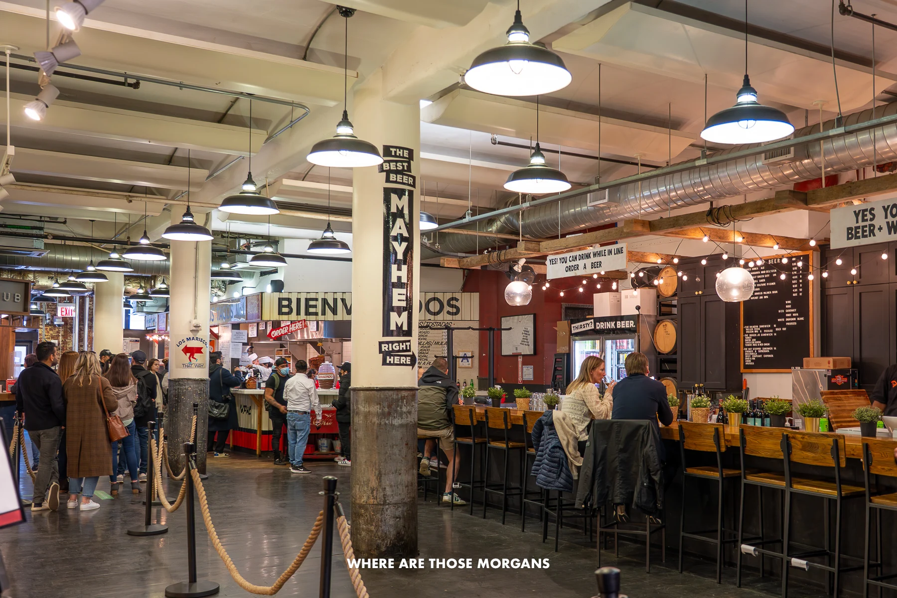 People eating and drinking inside Chelsea Market in New York