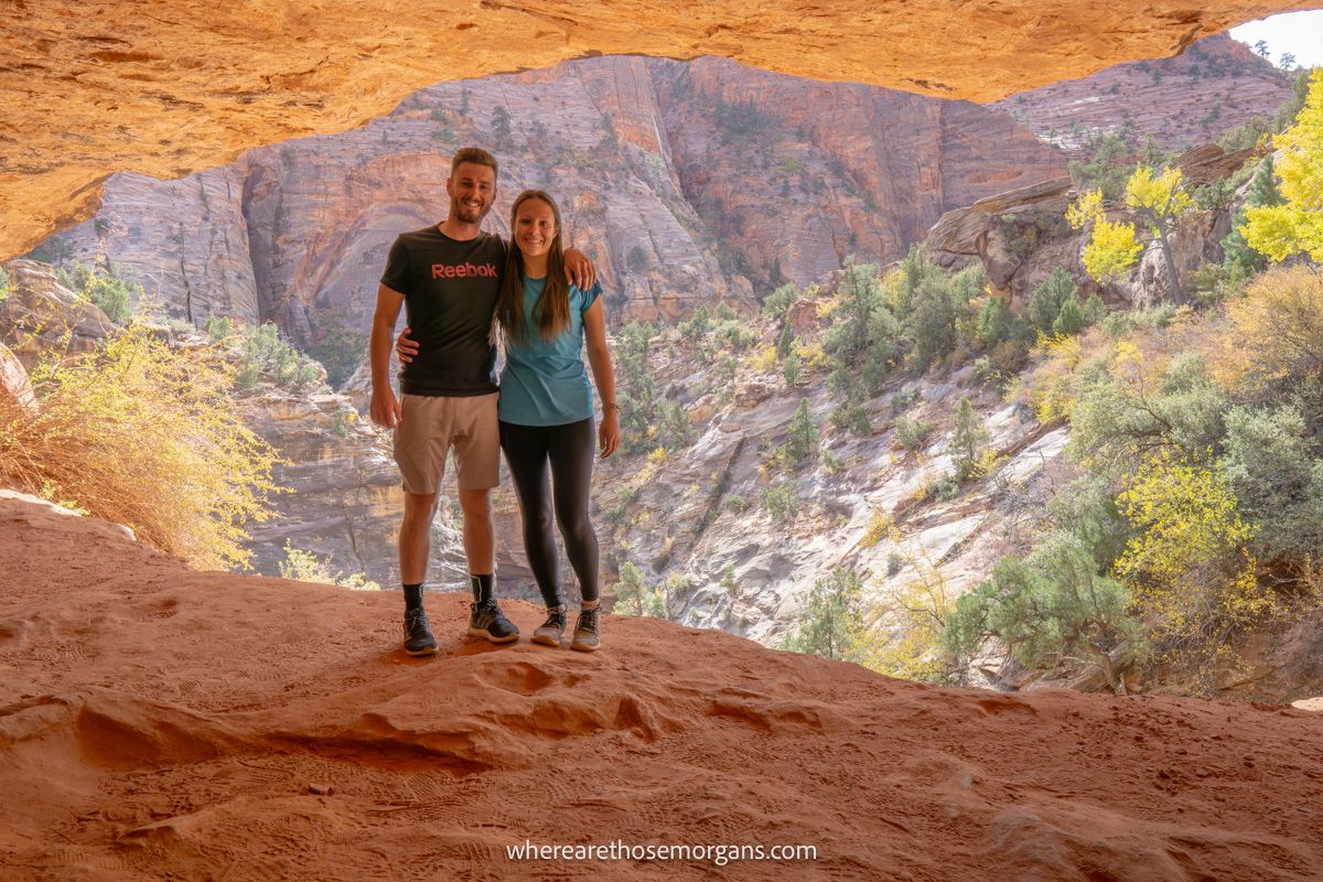 Photo of Mark and Kristen Morgan from Where Are Those Morgans standing together inside a sandstone cave in Utah