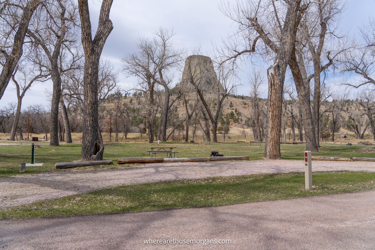 Photo of a Belle Fourche River Campground in Wyoming empty spaces with trees and a rock formation in the distance