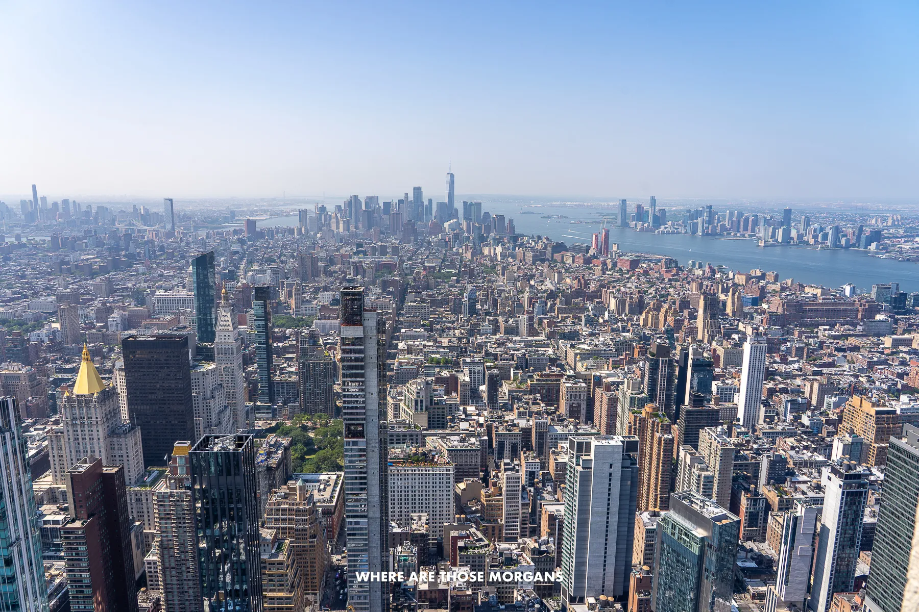 City skyline photo of New York from the top of Empire State Building on a clear but hazy day