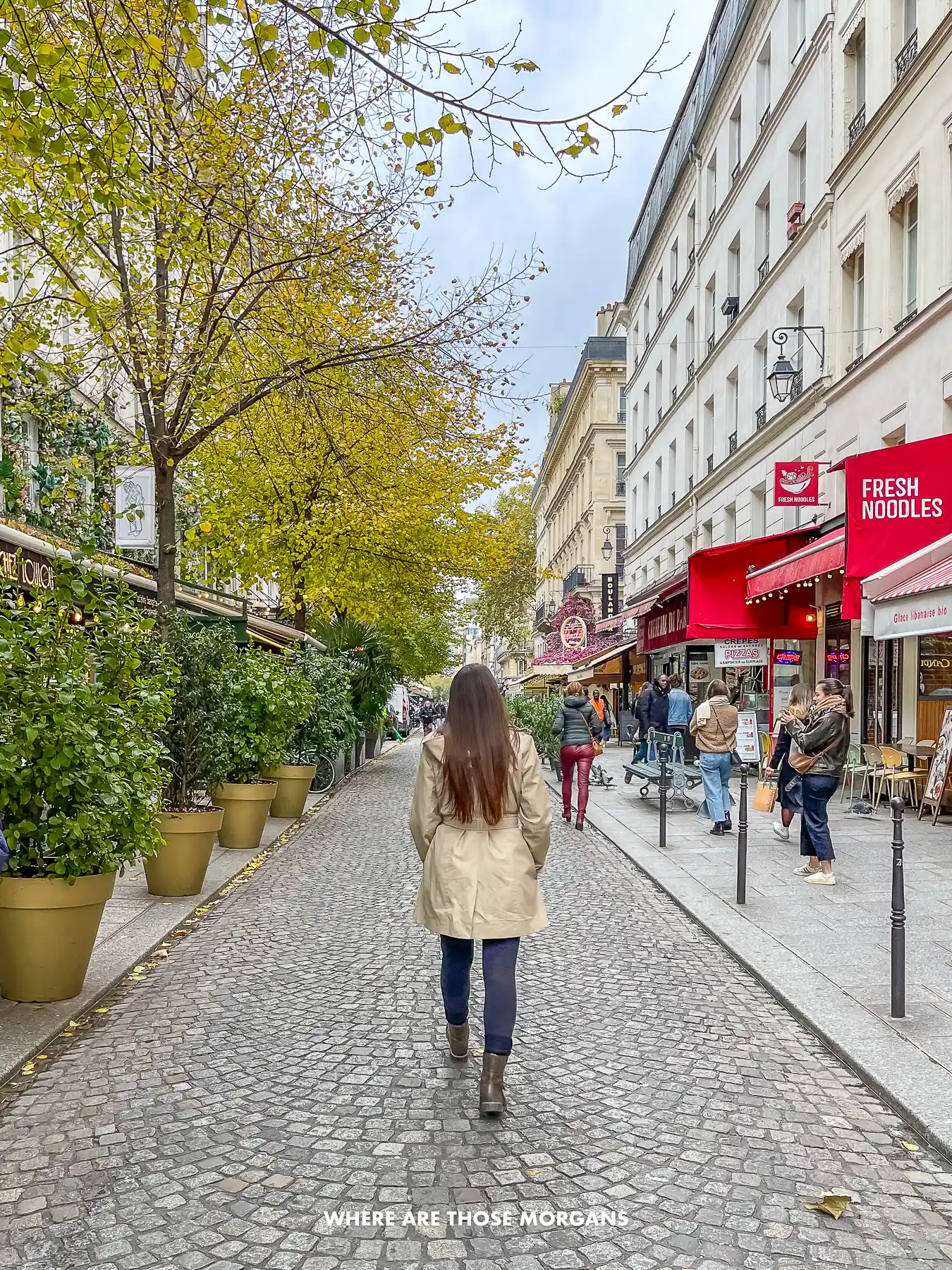 Photo of Kristen Morgan walking around Le Marais in Paris in a coat in November