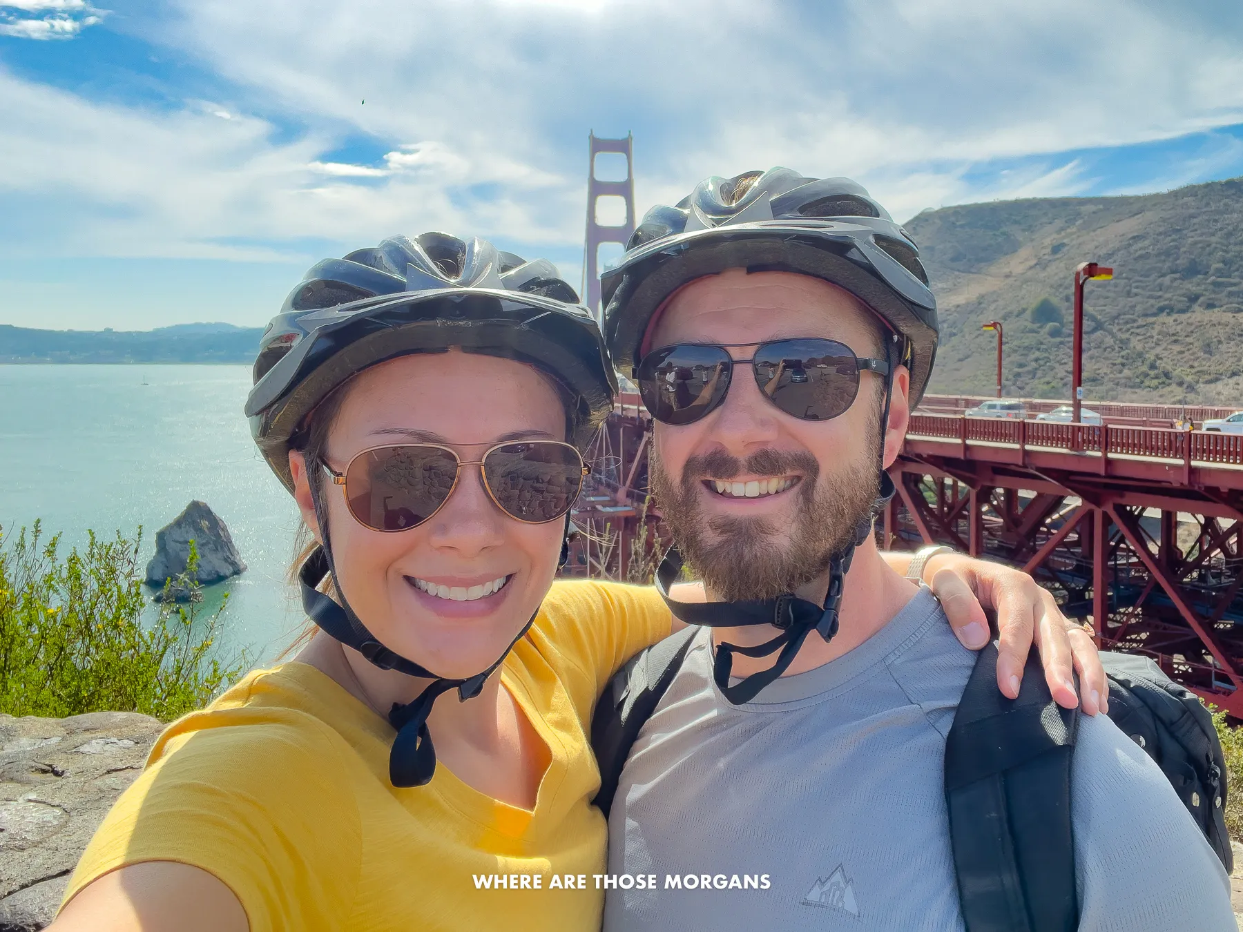 Mark and Kristen from Where Are Those Morgans taking a selfie with helmets on in front of the Golden Gate Bridge in San Francisco