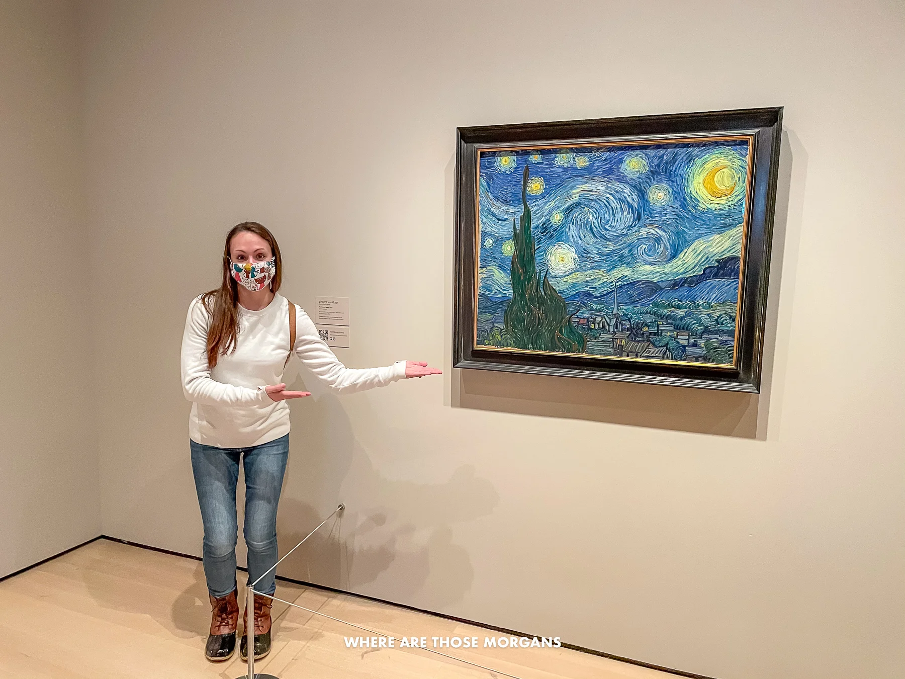 Kristen from Where Are Those Morgans standing next to and pointing at Starry Night by Van Gogh in NY MoMA