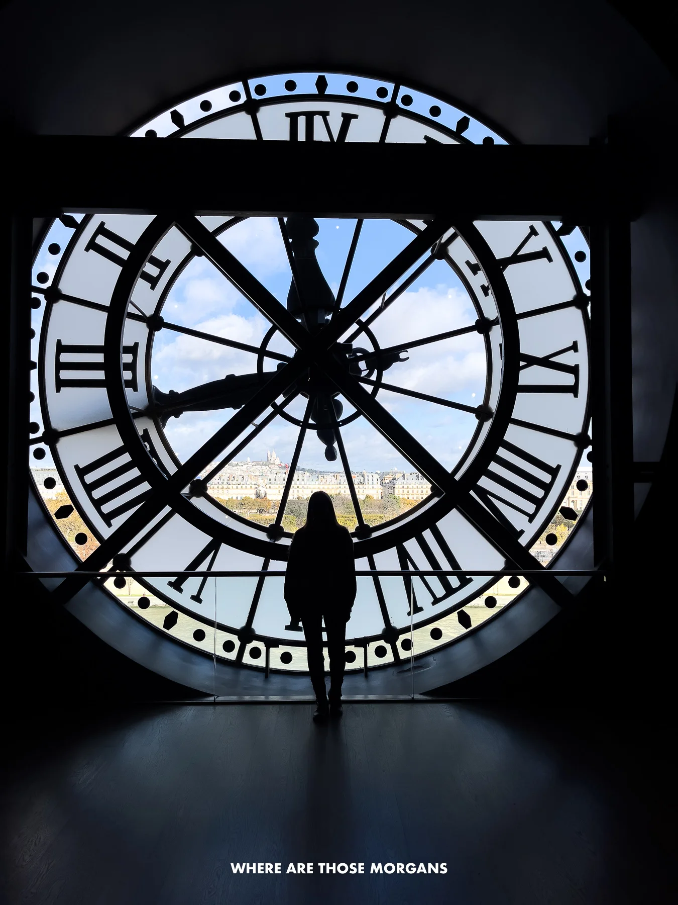 Kristen from Where Are Those Morgans silhouetted in front of the massive clock tower in the Orsay Museum in Paris