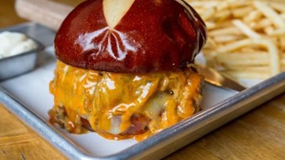 Photo of a burger and fries on a metal tray