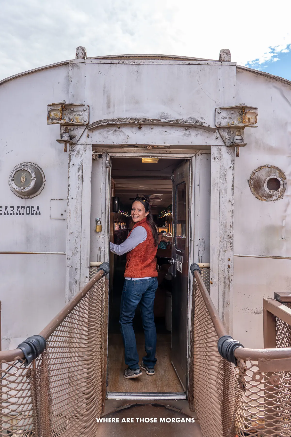 Kristen from Where Are Those Morgans walking from an outdoor to an indoor train carriage in Arizona