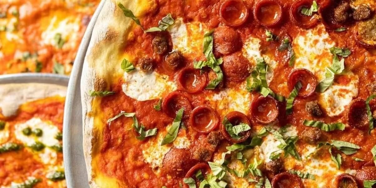 Close up photo of pizza with pepperoni and sausage