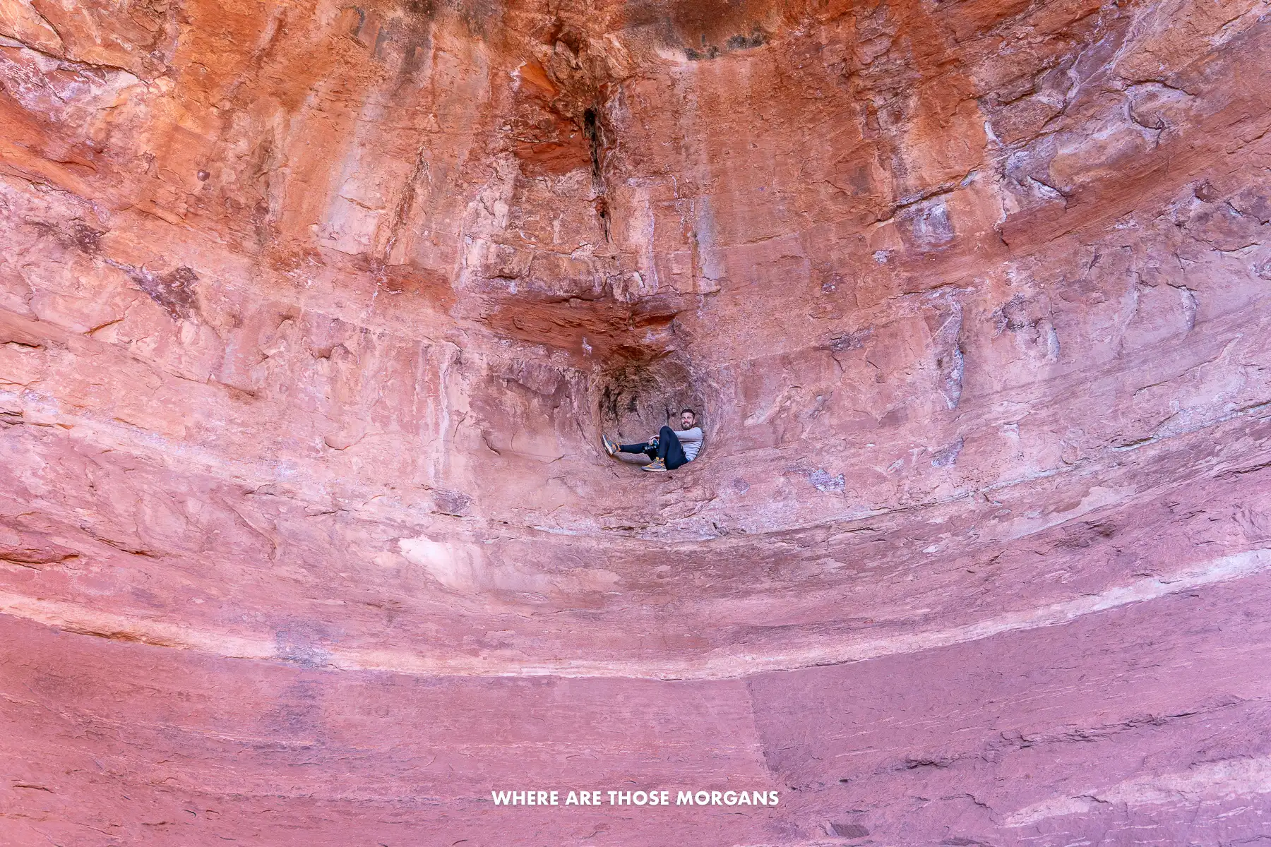 Mark from Where Are Those Morgans sat inside a small sphere-shaped alcove at the back of Birthing Cave in Sedona
