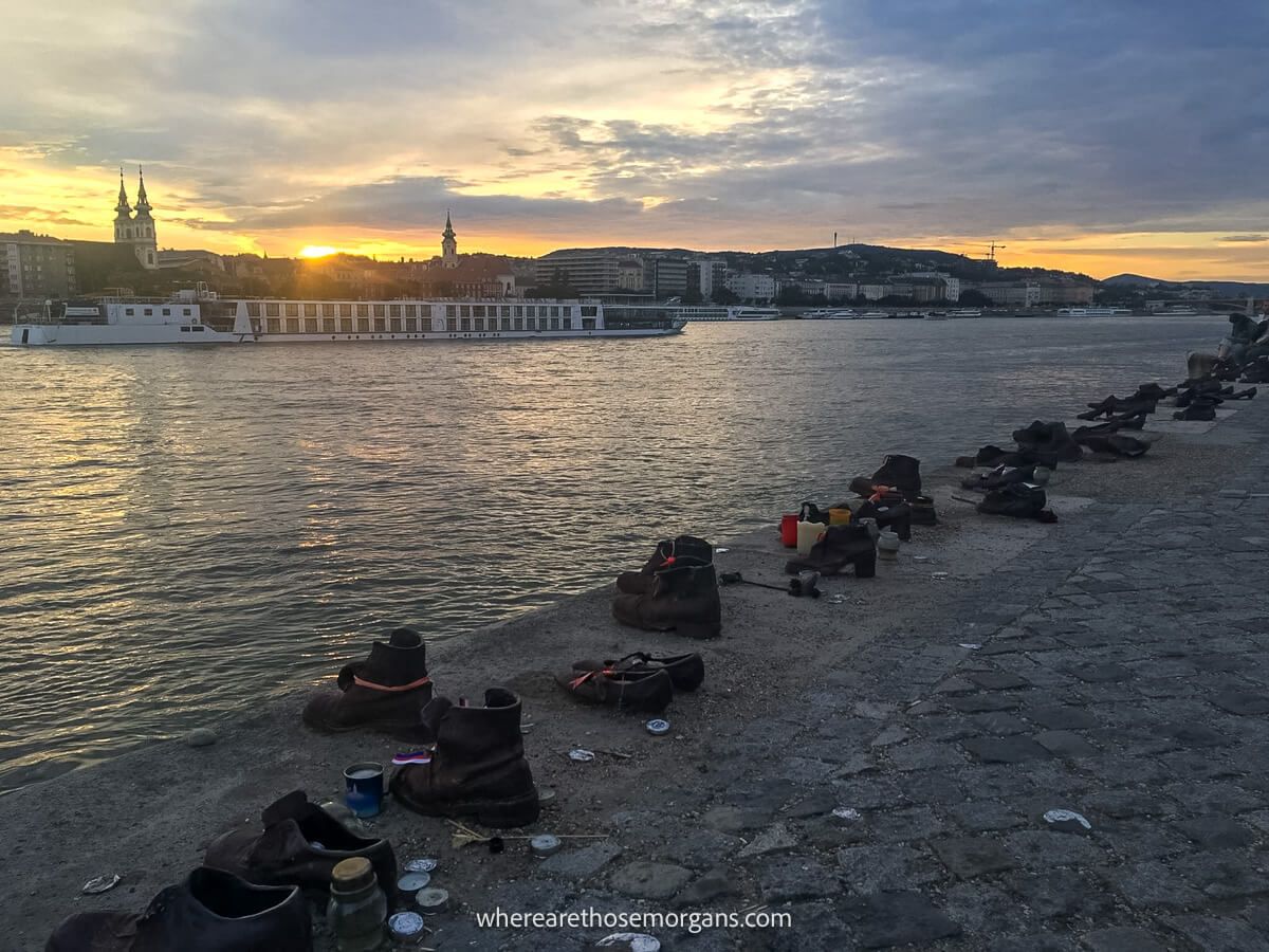 Lots of pairs of iron shoes stuck to concrete along the banks of the Danube in Budapest at sunset