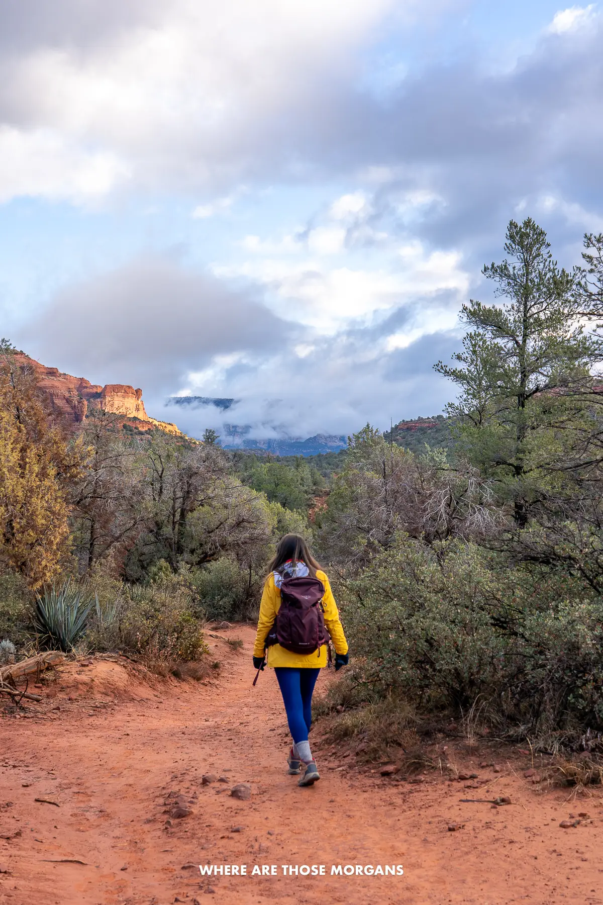 Kristen from Where Are Those Morgans hiking into Boynton Canyon in Sedona under a cloudy sky