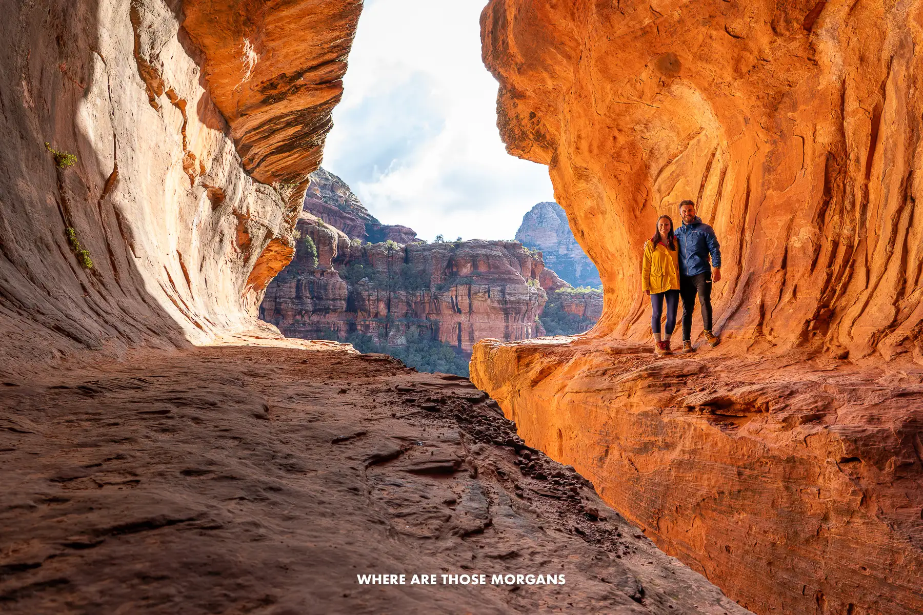 Mark and Kristen from Where Are Those Morgans standing alone inside a tunnel-like cave in Sedona called the Subway Cave