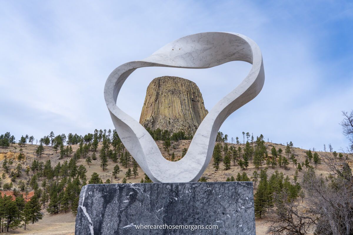 Photo of a rock formation framed through a metal sculpture